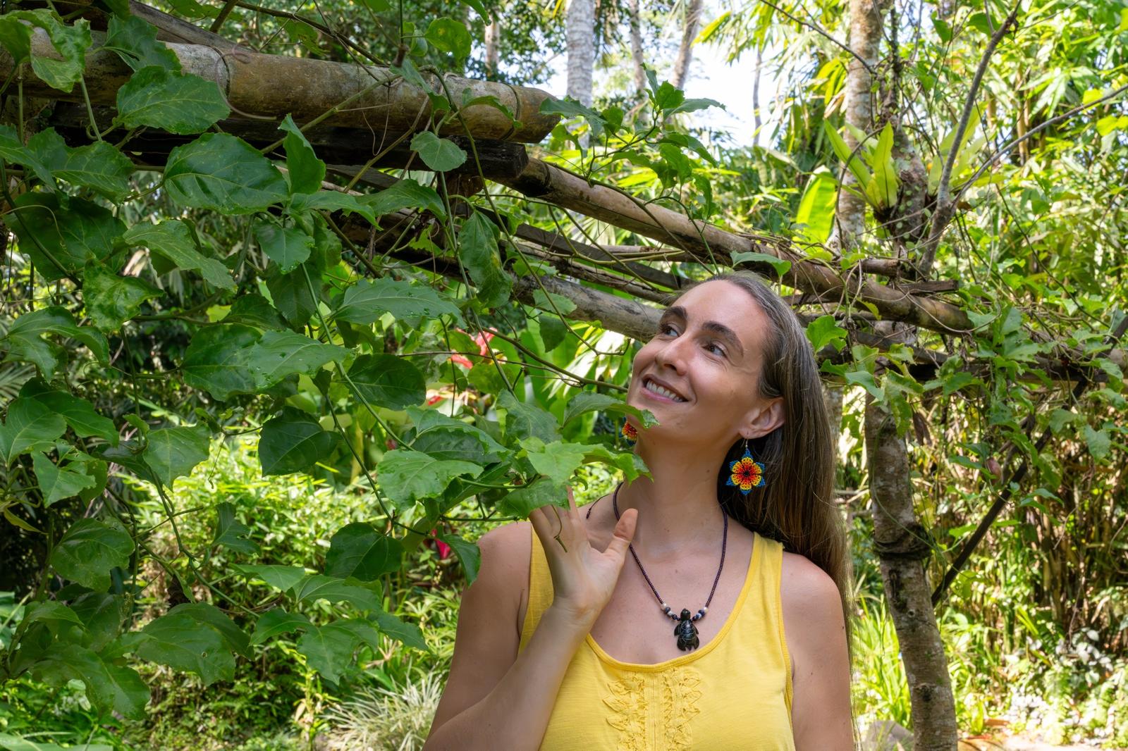 Andréanne smiling among the vines in a lush Bali garden — Sacred Feminine Medicine