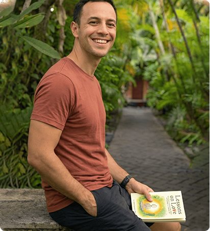 A reader with Lessons on Love in a garden