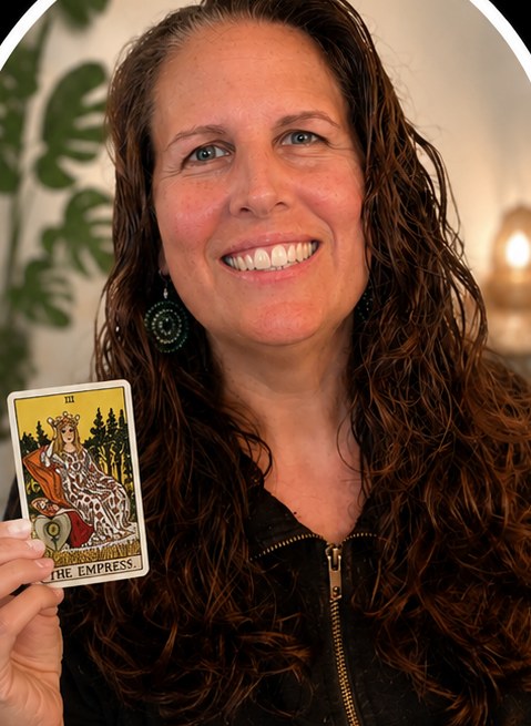 A client smiling, holding The Empress card